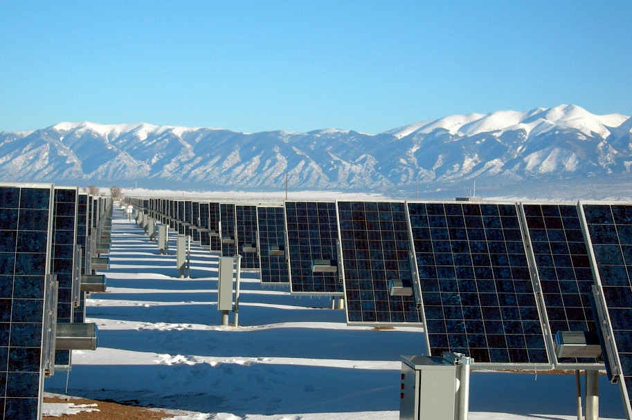 Rows of solar panels arranged in front of mountain range